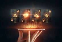 In the hands of a smartphone with playing cards, black-gold background. Concept of online gambling, online casino. Copy space.